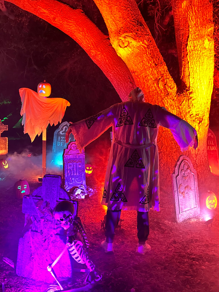 Back view of the Veni Vidi Vici Kimono in an outdoor nighttime scene, featuring detailed geometric motifs on organic Turkish cotton boho robe.