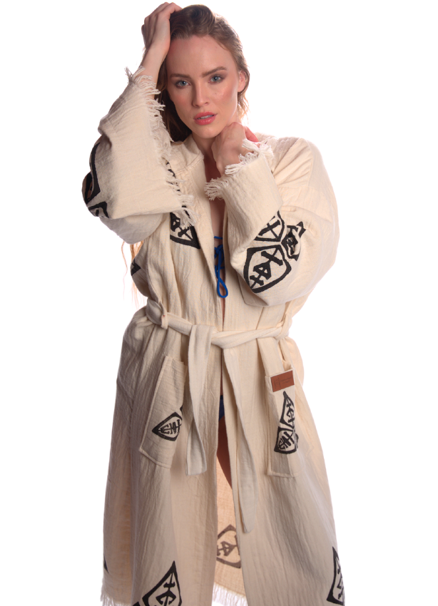 Female model posing in the Veni Vidi Vici Kimono, unisex festival robe featuring handcrafted black geometric symbols on lightweight organic cotton.