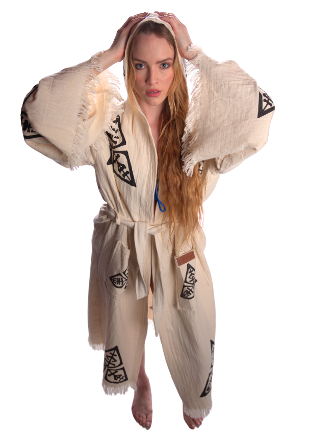 Female model wearing the Veni Vidi Vici organic cotton kimono with geometric spiritual motifs, unisex boho festival kimono styled in studio lighting.