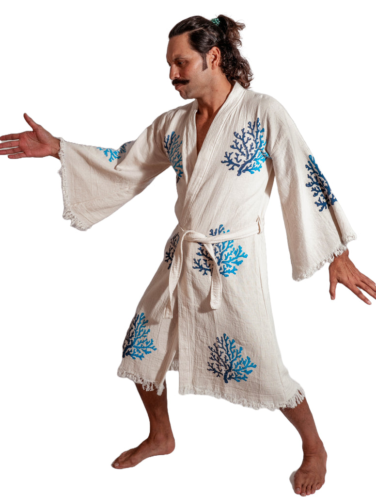 Man modeling Organic Reef Kimono with blue coral embroidery, standing in a dynamic pose on white background.