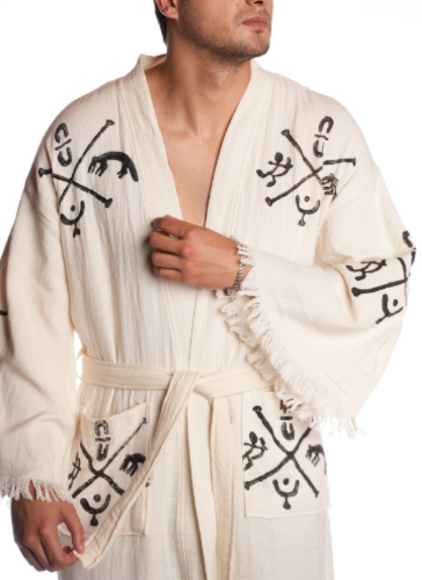 Organic cotton Gobekli Kimono in sand beige with hand-embroidered ancient Gobeklitepe symbols on the front panel, showcasing artisanal texture and premium craftsmanship.