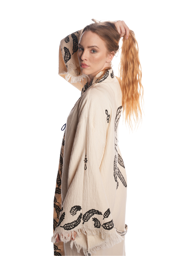 Side profile of the Dreamcatcher Kimono highlighting the flowing lightweight texture, feather motif borders, breathable organic cotton fabric, and relaxed bohemian fit perfect for festivals and daily wear.