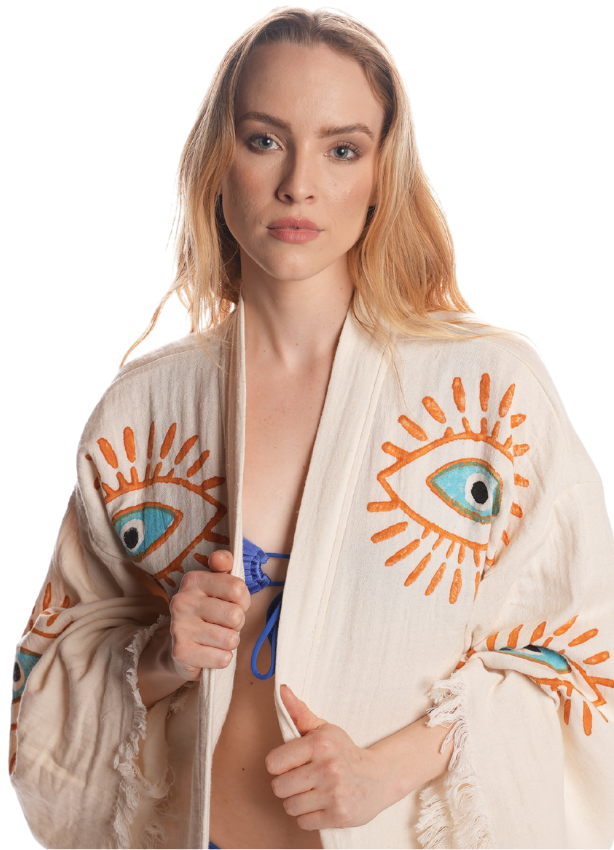 "Woman wearing Organic Evil Eye Kimono with orange and blue eye motifs, front view."