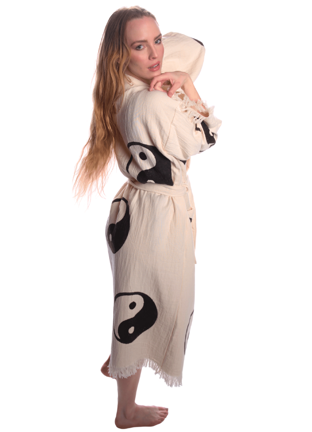 Woven Yin Yang symbol detail on organic cotton kimono, black and white spiritual design.